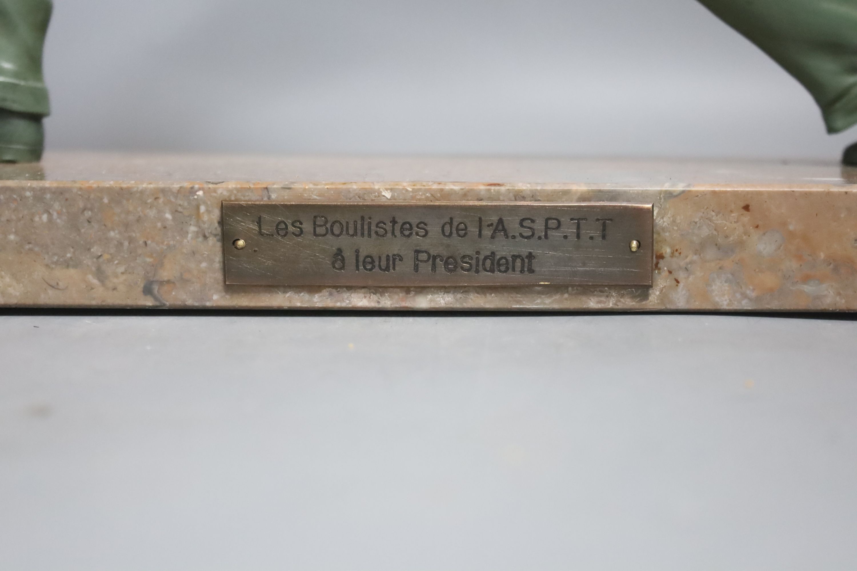 An Art Deco model of a gentleman playing boules. Marble base with plaque reading ‘Les boulistes de l-A.S.P.T.T a leur President’ - 33.5cm